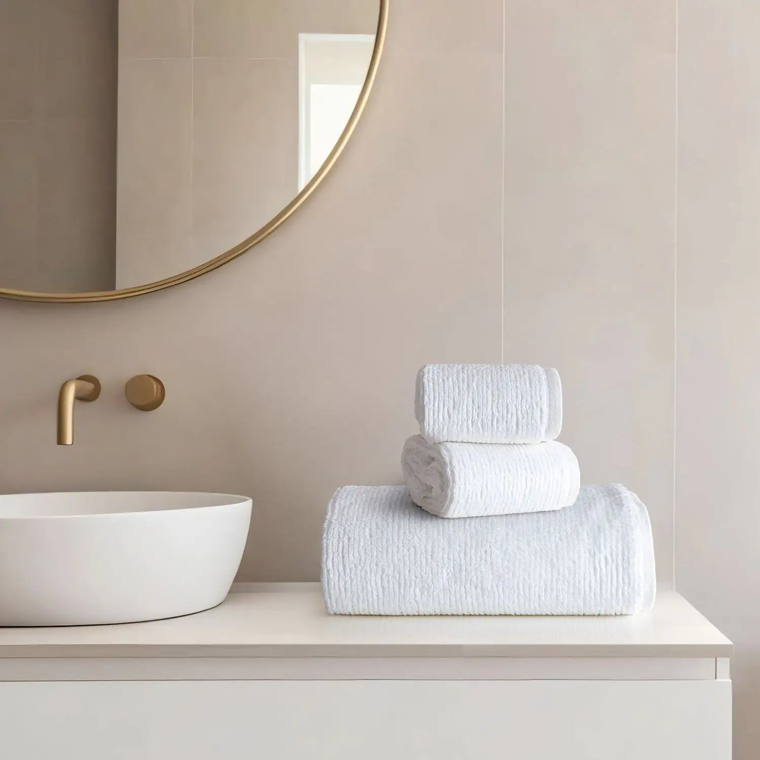 Earth Cotton 3-piece snow white towel set – 100% cotton towels stacked beside a modern wash basin