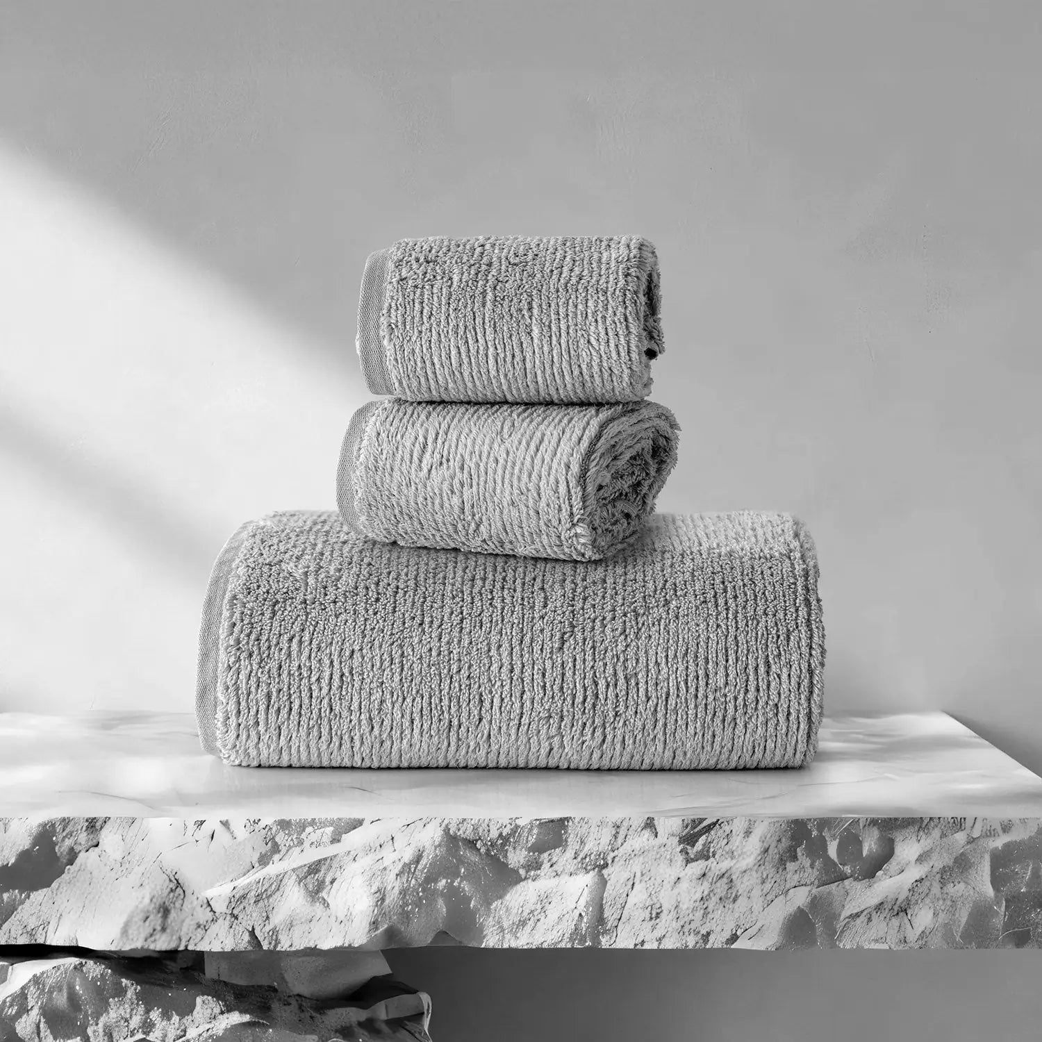 Earth Cotton 3-piece stone towel set – 100% cotton towels folded on stone surface
